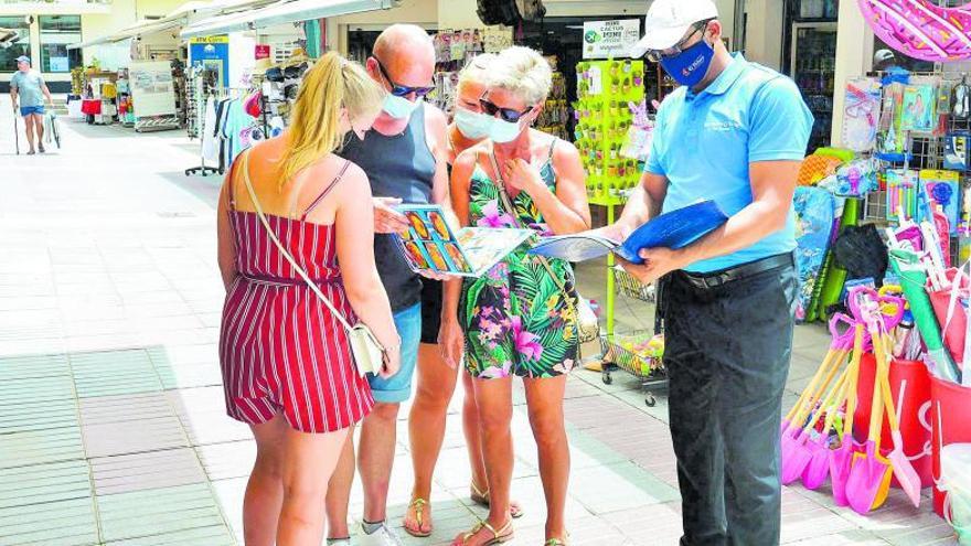 El empleado de un restaurante de Gran Canaria atiende a turistas que portan sus mascarillas.