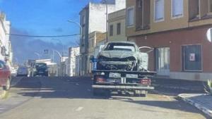 Una grúa llevándose el vehículo calcinado en Montijo. CRÓNICAS DE UN PUEBLO