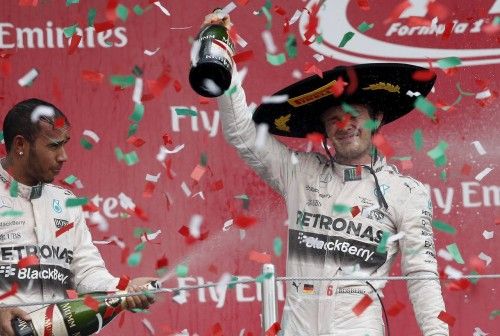 Mercedes Formula One driver Nico Rosberg of Germany celebrates next to his teammate Lewis Hamilton of Britain after winning the Mexican F1 Grand Prix at Autodromo Hermanos Rodriguez in Mexico City