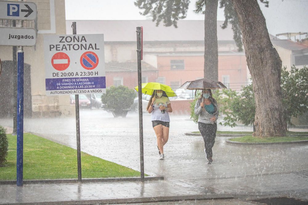 Un buen chaparrón ha sorprendido a primera hora a los peatones en el centro histórico de Orihuela. Las lluvias y tormentas se prolongarán esta tarde con posibilidad de granizo.