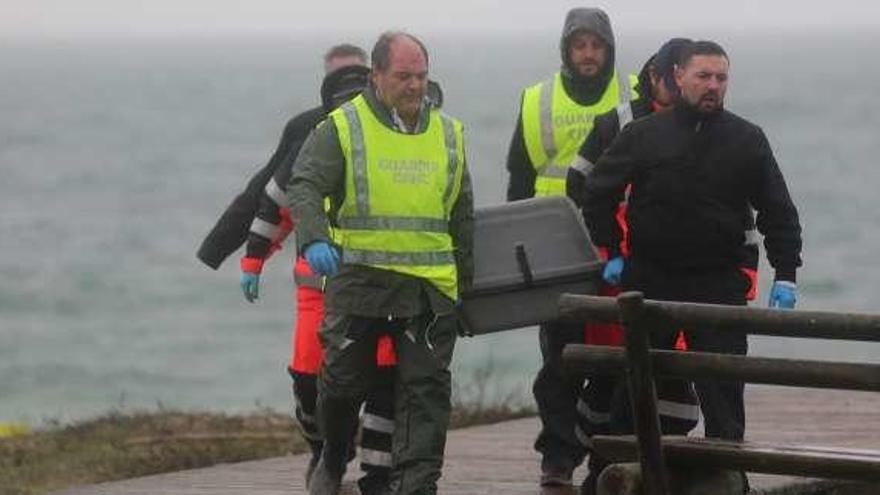 Guardia Civil y emergencias retiran el cuerpo de la playa. // Muñiz