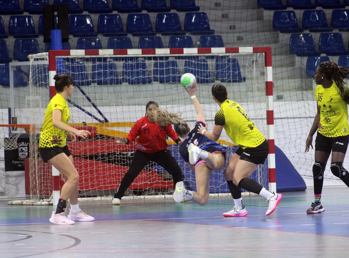 Marta da Silva, central de las Lobas, se dispone a lanzar ante la portera Madeleine Cortez, presionada por Romina Machín.