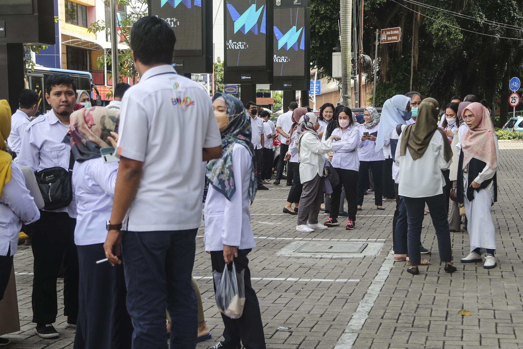 People stay outside after a 5.6 magnitude earthquake shakes West Java