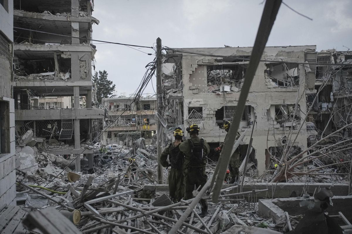 Israeli soldiers search for survivors amid the rubble of residential buildings destroyed by an Iranian missile strike in the central Israeli city of Bat Yam, on Sunday, June 15, 2025. (AP Photo/Ohad Zwigenberg)