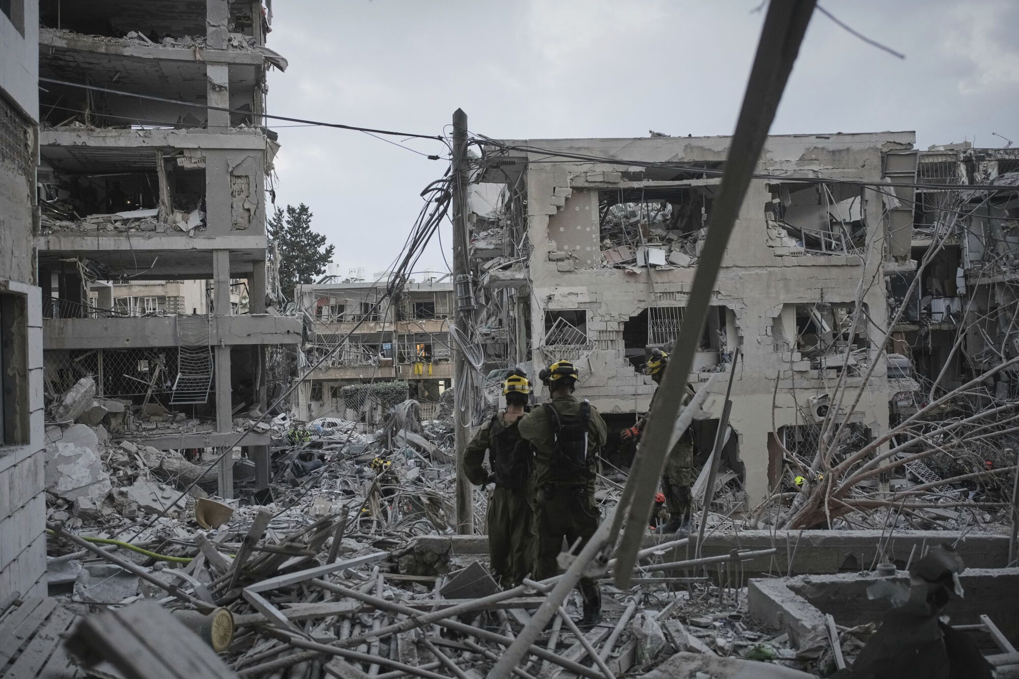 Israeli soldiers search for survivors amid the rubble of residential buildings destroyed by an Iranian missile strike in the central Israeli city of Bat Yam, on Sunday, June 15, 2025. (AP Photo/Ohad Zwigenberg)