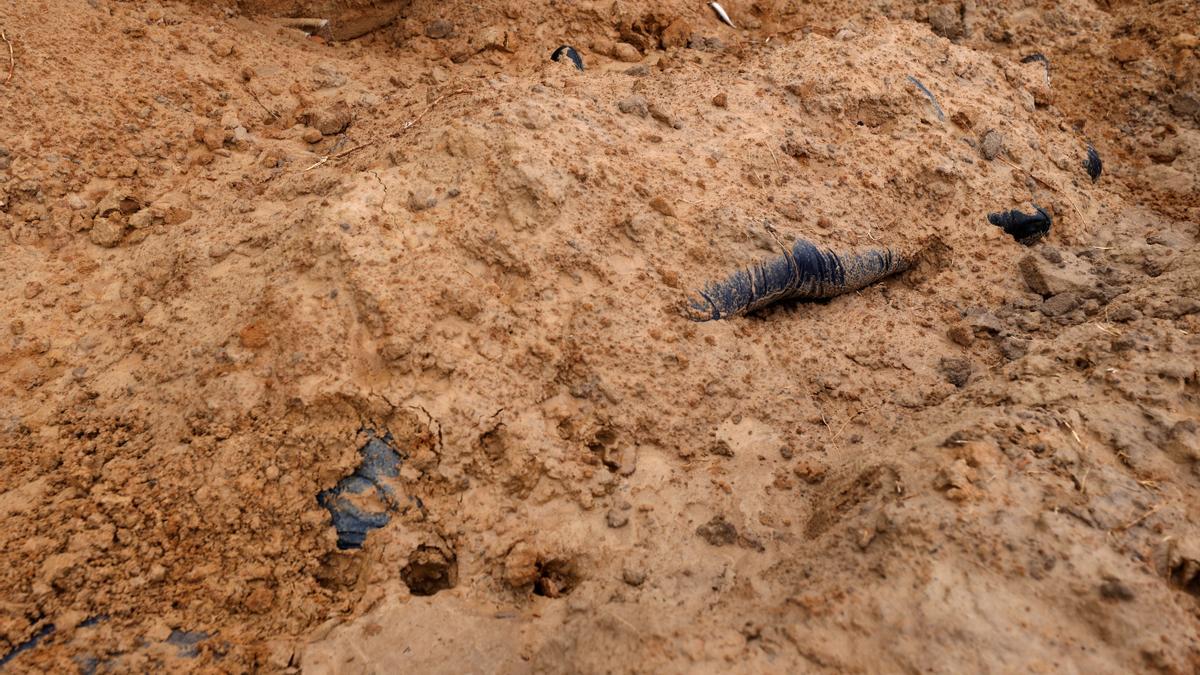 Bodies of civilians, who according to residents were killed by Russian army soldiers and then buried along with others in one grave, are seen, amid Russia's invasion of Ukraine, in Bucha