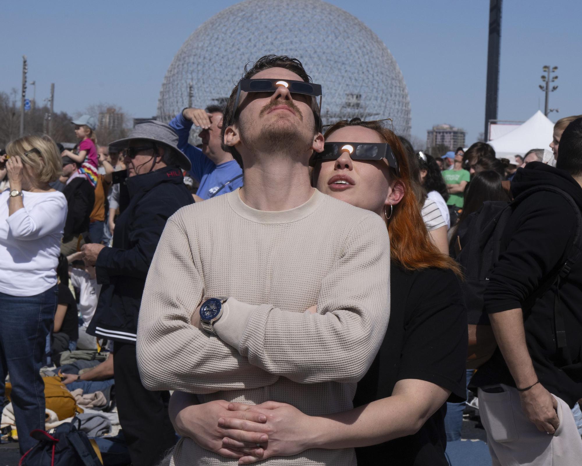People watch the total solar eclipse at Parc Jean Drapeau, in Montreal, Monday, April 8, 2024. (Ryan Remiorz/The Canadian Press via AP) / MANDATORY CREDIT