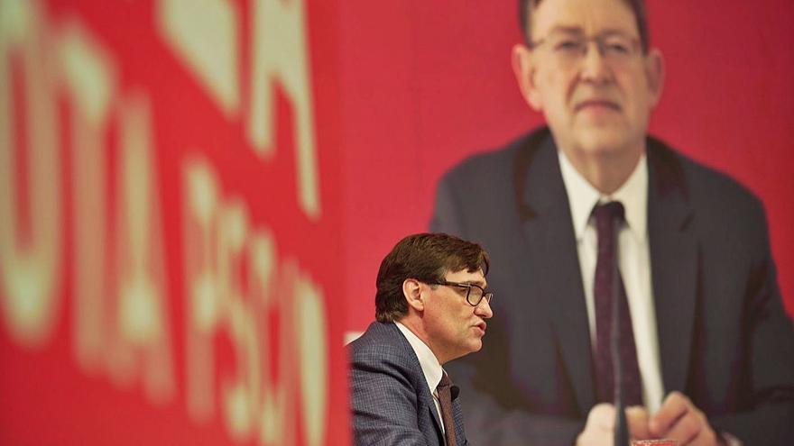 Illa dialoga con Puig (en la pantalla) en el acto de campaña del PSC. | EUROPA PRESS/OLLER
