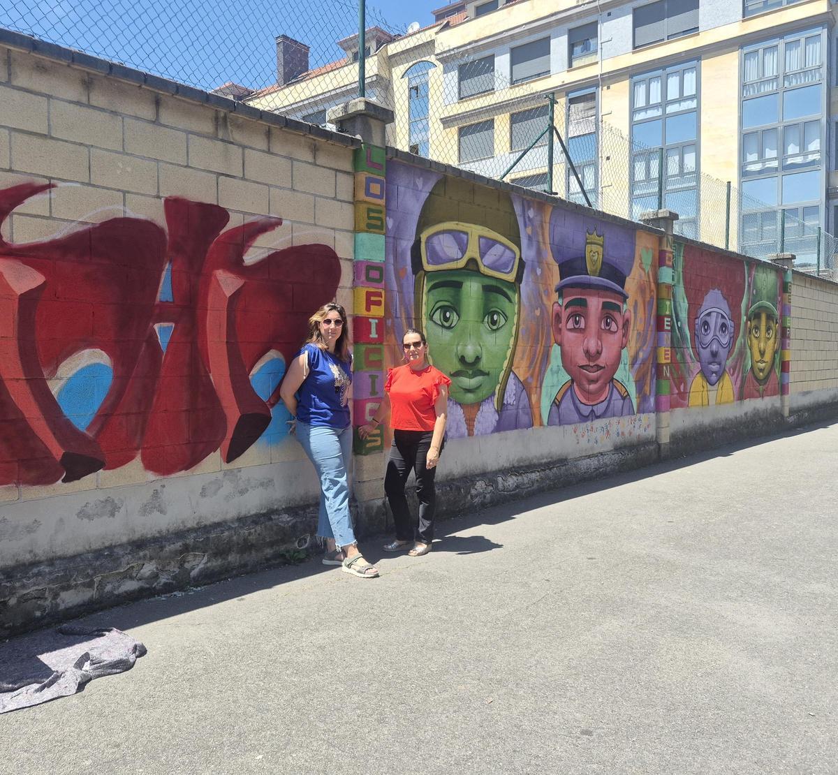 Por la izquierda, Guiomar Ardura y Noemí González, vocal de la AMPA, ante dos de los murales que participan en el concurso.