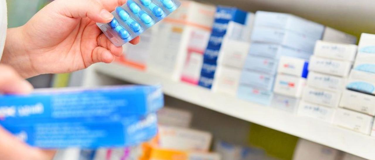 La responsable de una farmacia dispensa algunos antibióticos.