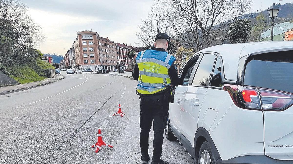 Un policía local de San Martín realiza un control de tráfico en El Entrego. | LNE