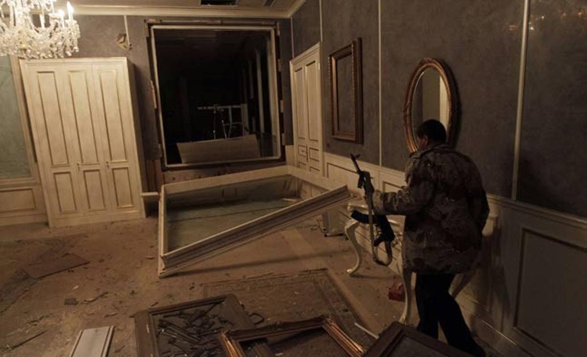 Afins a Gaddafi mostren, en una visita guiada, els danys causats pels atacs aeris de l’OTAN en una sala de conferències d’un edifici governamental a Trípoli (Líbia).