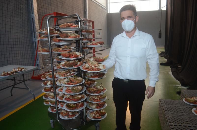 Un camarero con platos de centollo listo para consumir.
