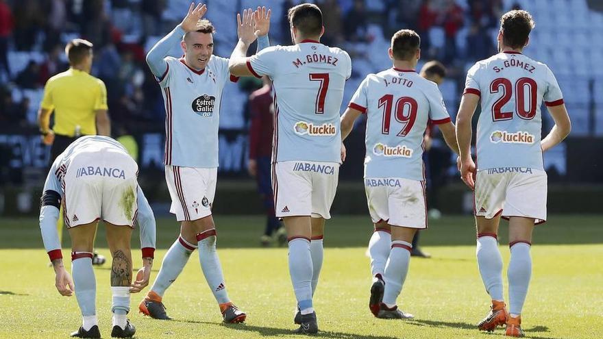 Aspas y Maxi chocan sus manos para celebrar, en presencia de varios compañeros, el segundo gol del Celta al Eibar. // José Lores