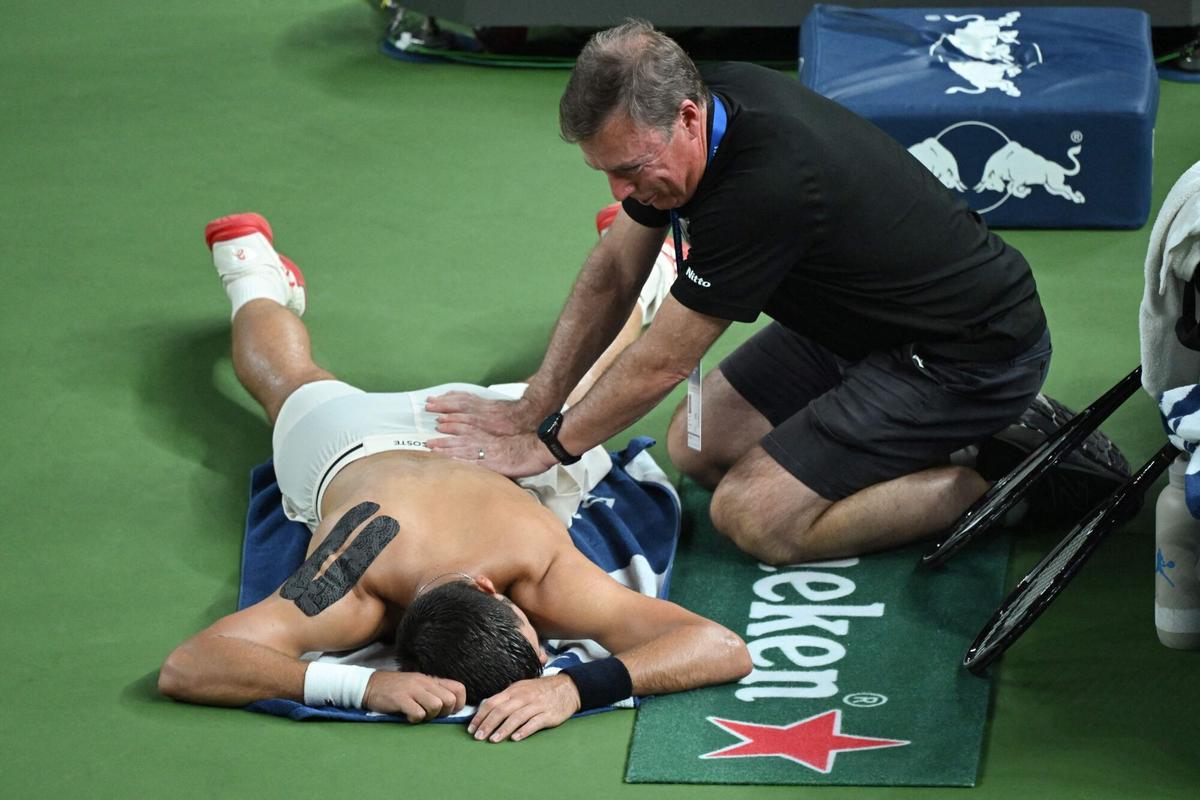 Serbia's Novak Djokovic receives physio during his men's singles semi-final match against Monaco's Valentin Vacherot at the Shanghai Masters tennis tournament in Shanghai on October 11, 2025. (Photo by Jade Gao / AFP)