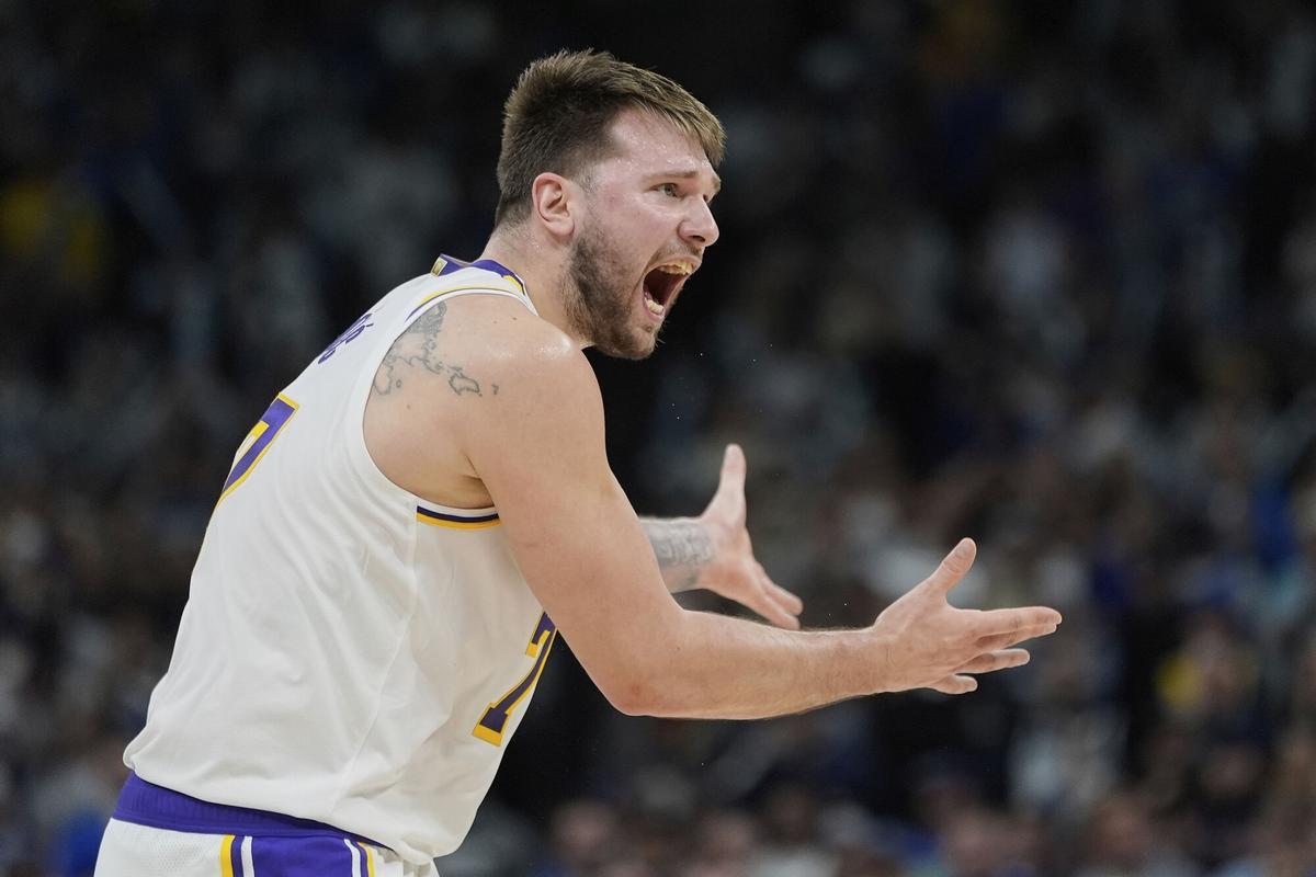 Los Angeles Lakers guard Luka Doncic (77) reacts after a foul called on the Lakers during the first half of Game 4 of an NBA basketball first-round playoff series against the Minnesota Timberwolves, Sunday, April 27, 2025, in Minneapolis. (AP Photo/Abbie Parr)