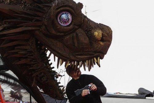 A worker prepares a dragon statue before the premiere of the HBO series "Game of Thrones" in New York