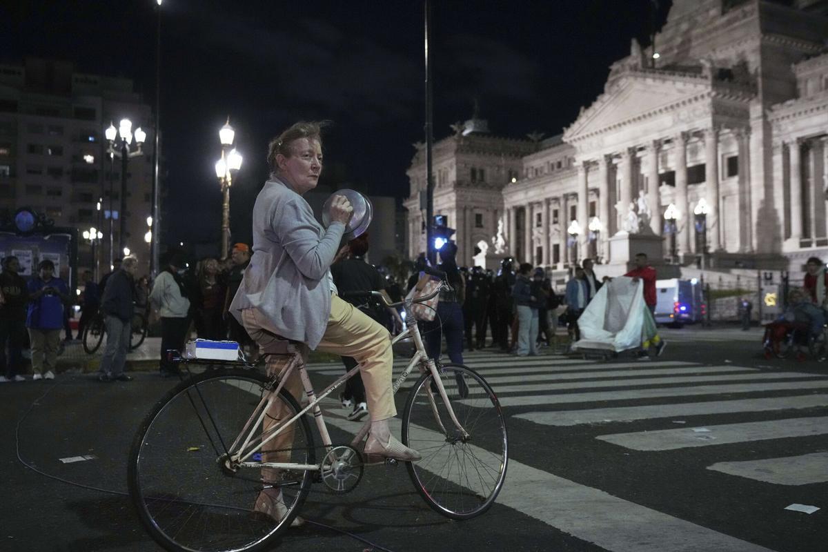 Adriana Reygadas, 71, bangs pots outside Congress during a protest for higher pensions and against austerity measures implemented by Javier Mileis government in Buenos Aires, Argentina, Wednesday, March 12, 2025. (AP Photo/Rodrigo Abd)