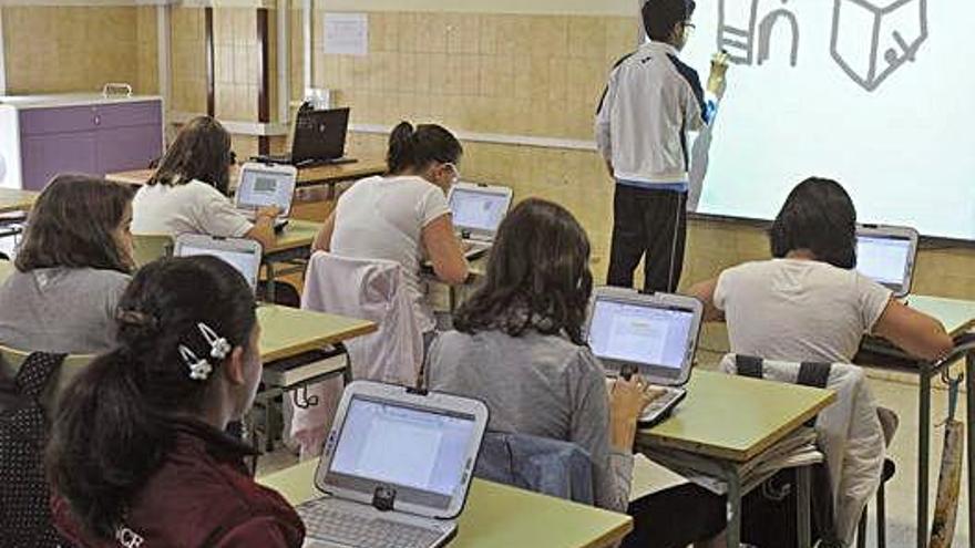 Niños trabajan con el ordenador en una escuela rural.