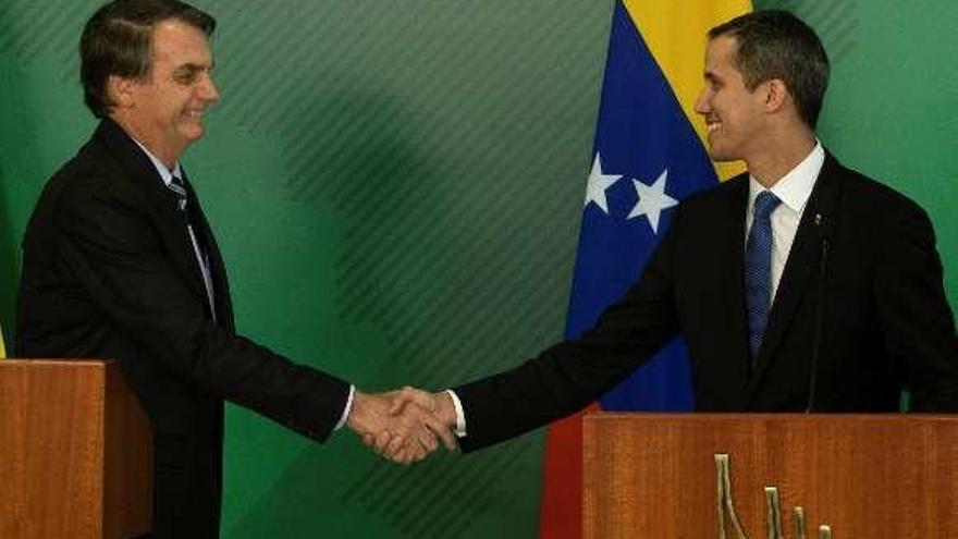 Jair Bolsonaro y Juan Guaidó se saludan ayer en Brasilia. // Efe