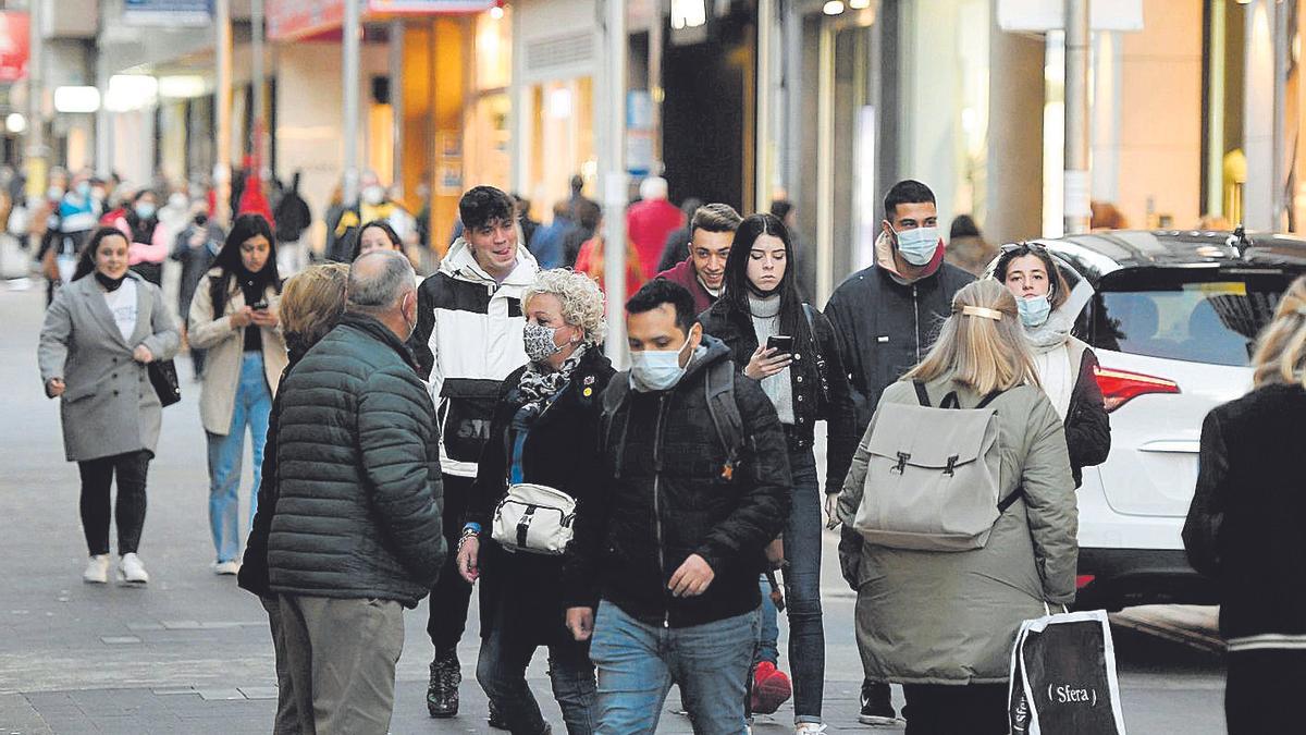 Gente con y sin mascarilla por la calle