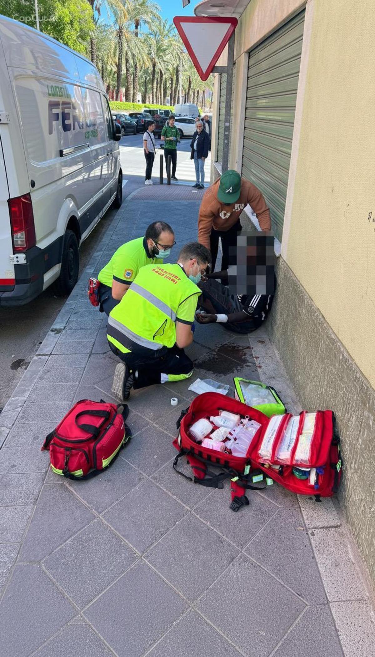 Personal sanitario atiende al hombre herido tras la reyerta en Carrús