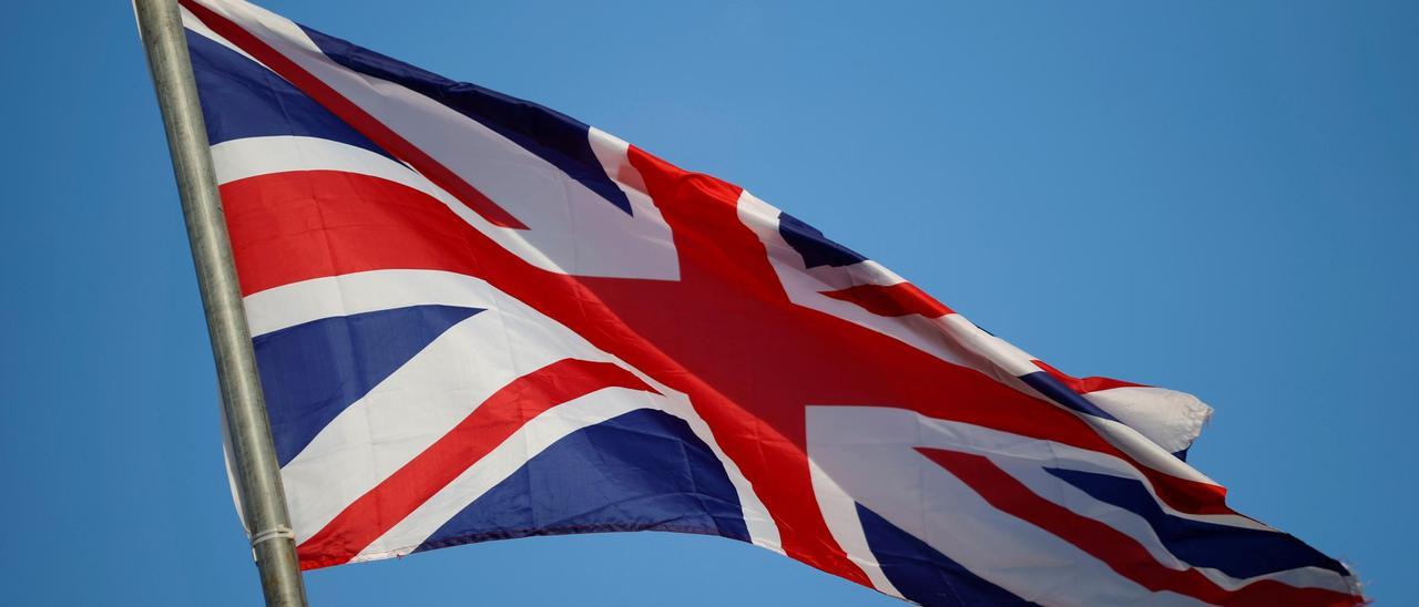 Union Jack flag flies above a Unionist mural in Larne