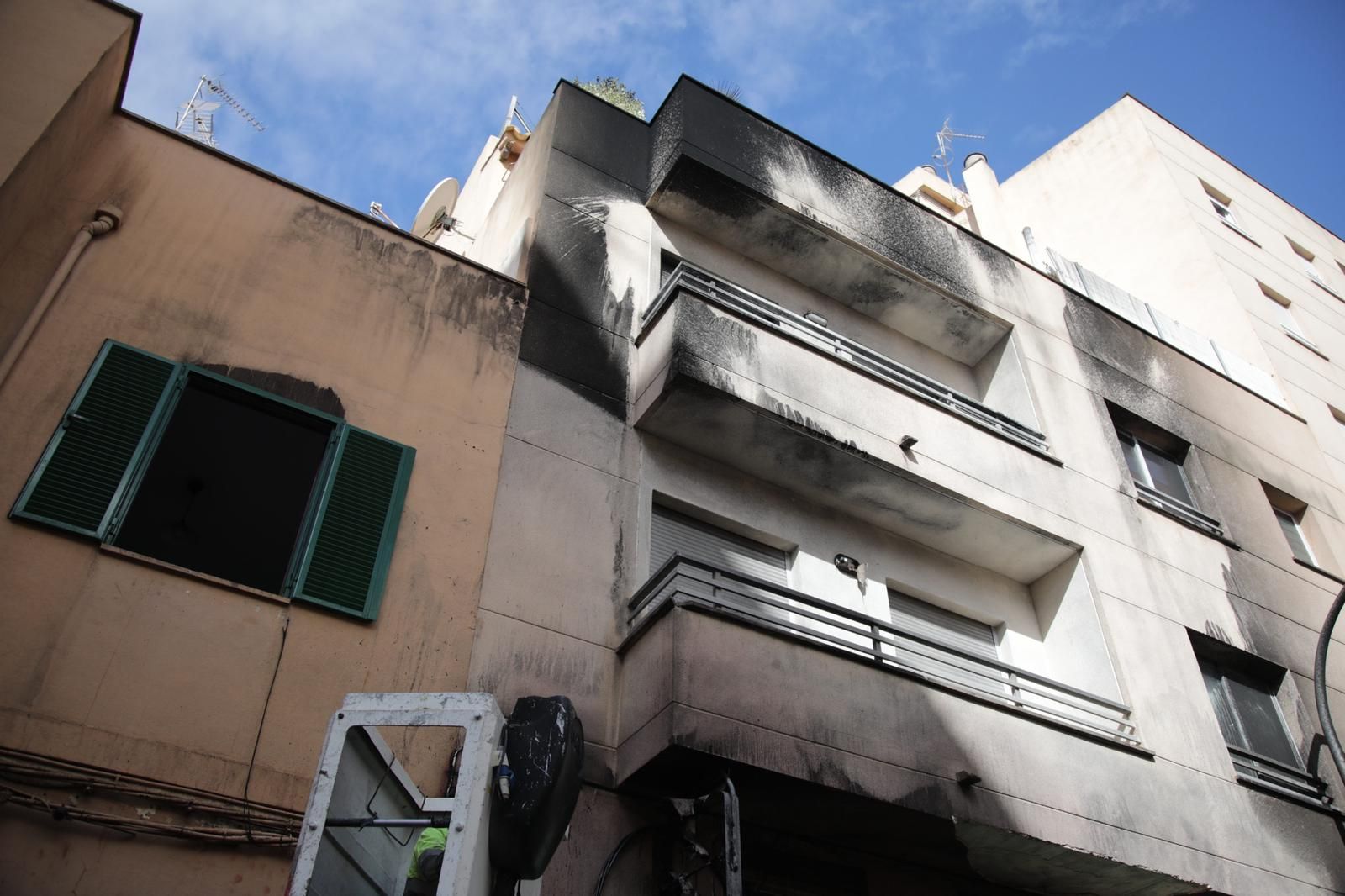 Un incendio destruye contenedores, coches y la fachada de una casa en Palma