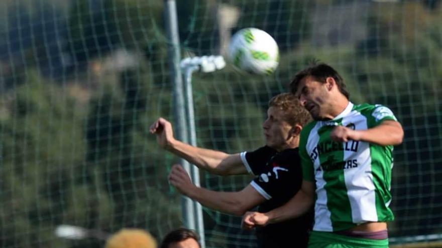 Alberto disputa un balón con un jugador local, en presencia de Keko.