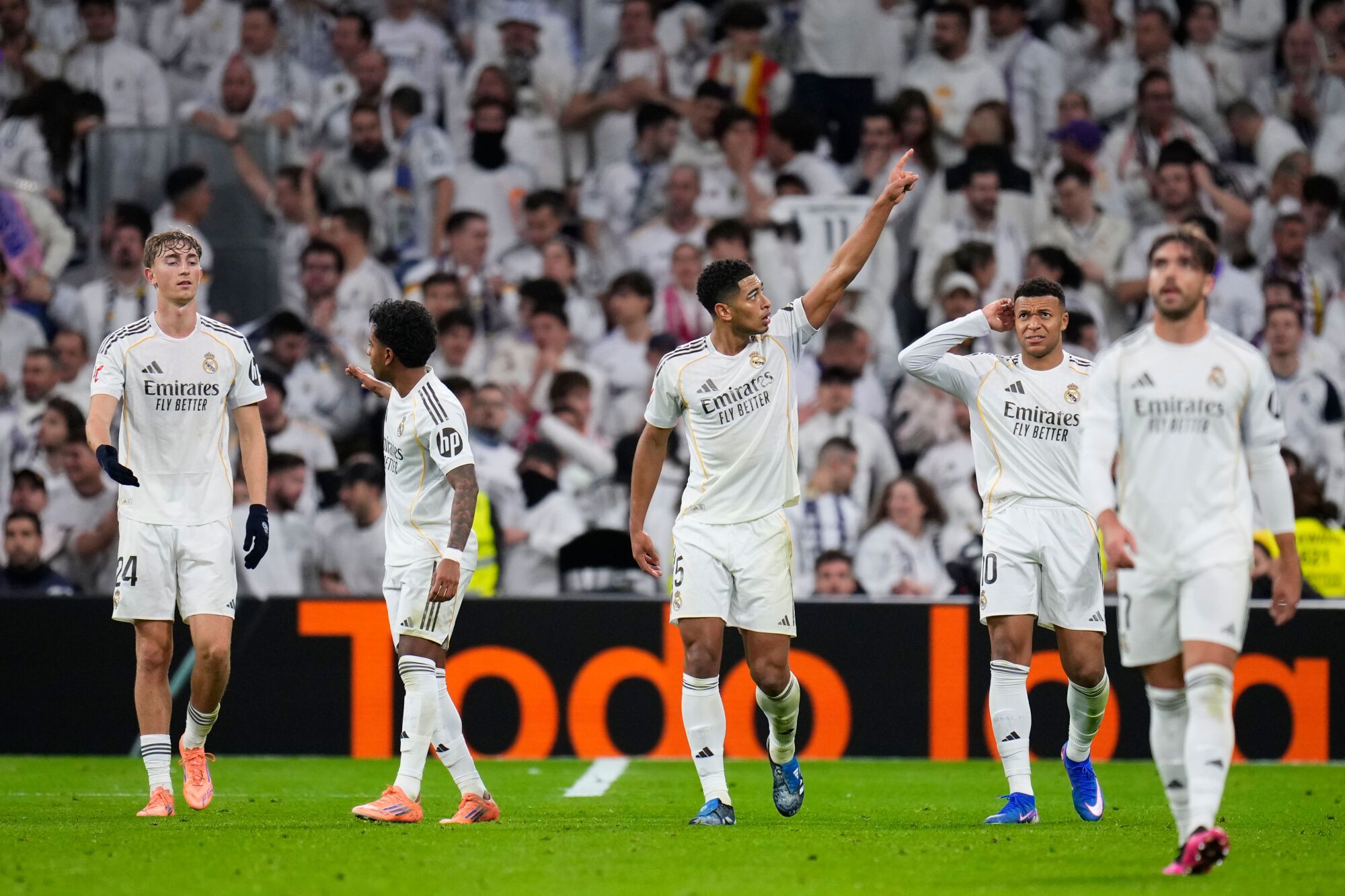 Real Madrid's Jude Bellingham, gestures towards the crowd as he celebrates after scoring the opening goal during the Spanish La Liga soccer match between Real Madrid and Sevilla in Madrid, Spain, Saturday, Dec. 20, 2025. (AP Photo/Manu Fernandez)