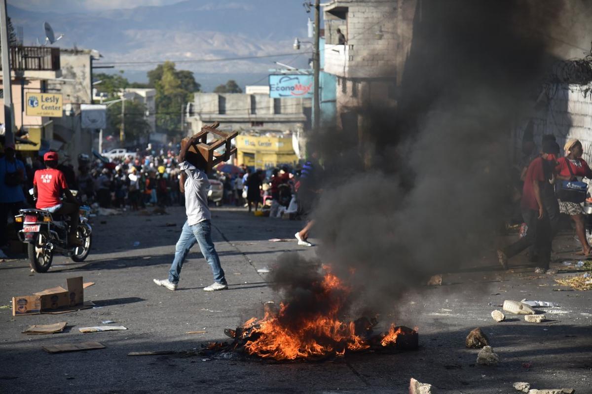 Demonstrators burn tires during a protest  in Port-au-Prince  on February 9  2019  - Demonstrators are demanding the resignation of Haitian President Jovenel Moise and protesting the Petrocaribe fund which for years Venezuela supplied Haiti and other Caribbean and Central American countries with oil at cut-rate prices and on easy credit terms  But investigations by the Haitian Senate in 2016 and 2017 concluded that nearly  2 billion from the program was misused   Photo by HECTOR RETAMAL   AFP