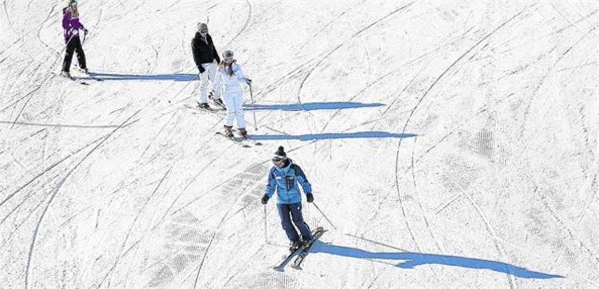 Uns esquiadors disfruten d’una jornada a la neu. Uns esquiadors disfruten d’una jornada a la neu.