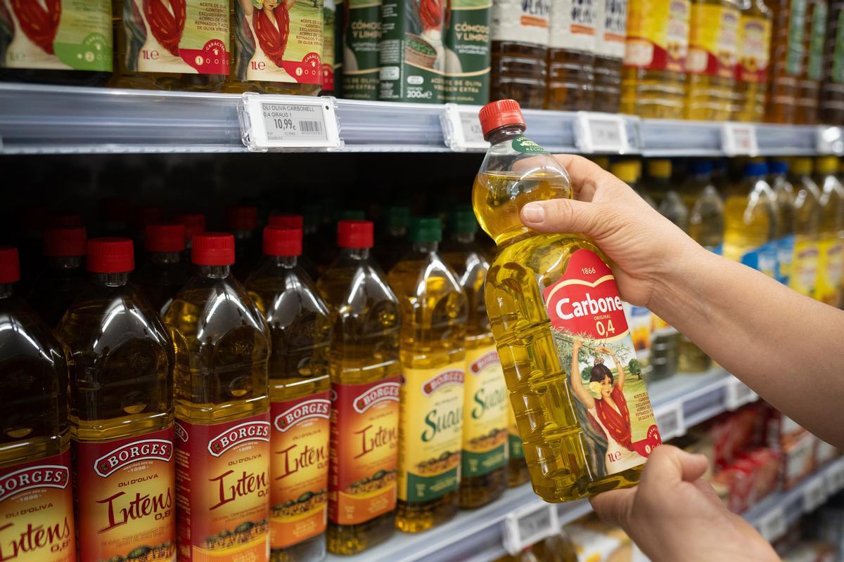 Una persona sostiene una botella de aceite, en Barcelona, Cataluña (España)