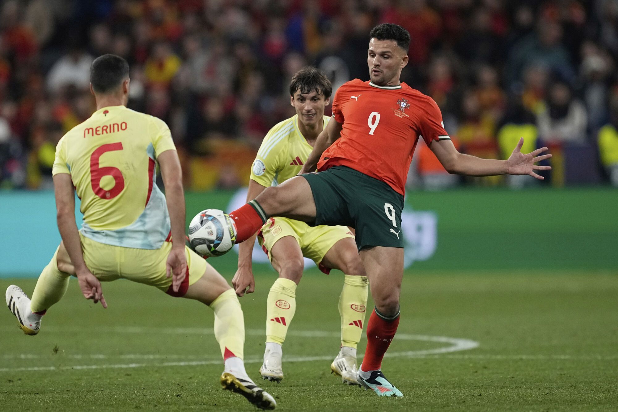 Portugal's Goncalo Ramos, center, vies for the ball against Spain's Mikel Merino, left, and Robin Le Normand during the Nations League final soccer match between Portugal and Spain at the Allianz Arena in Munich, Germany, Sunday, June 8, 2025. (AP Photo/Martin Meissner). EDITORIAL USE ONLY/ONLY ITALY AND SPAIN