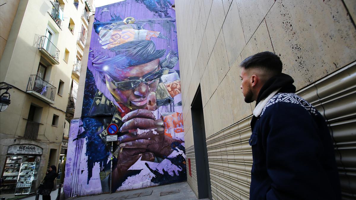 Conse, ante su mural dedicado al artista senegalés Makha Diop, en la calle de Ramelleres, en Barcelona., la semana pasada.