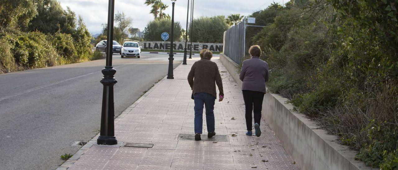 Dos mujeres caminan por el acceso a Llanera.