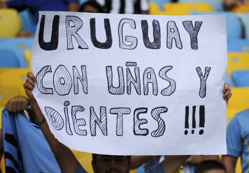 A Uruguay fan holds up a sign before the 2014 World Cup round of 16 game between Colombia and Uruguay at the Maracana stadium