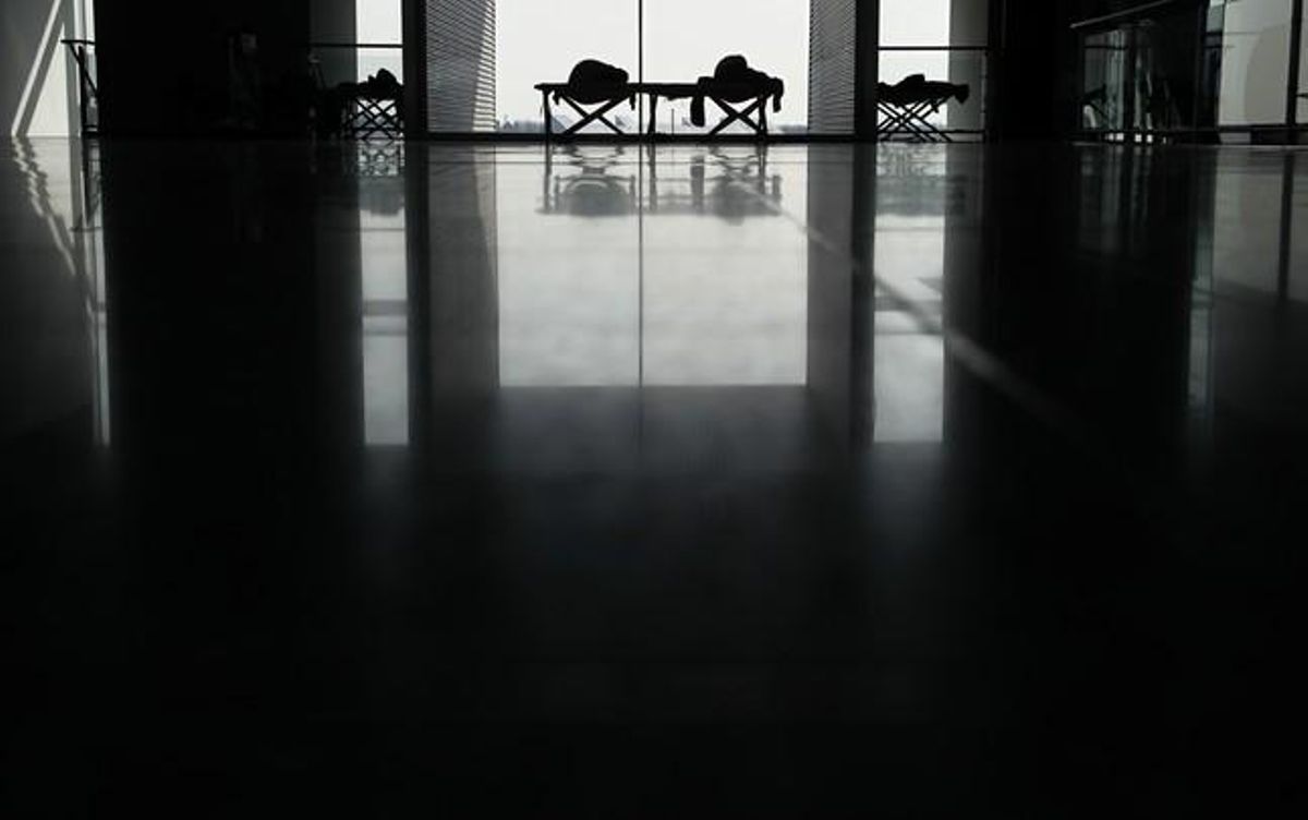 Passengers sleep on camp beds provided by airport operator Fraport at Frankfurt airport