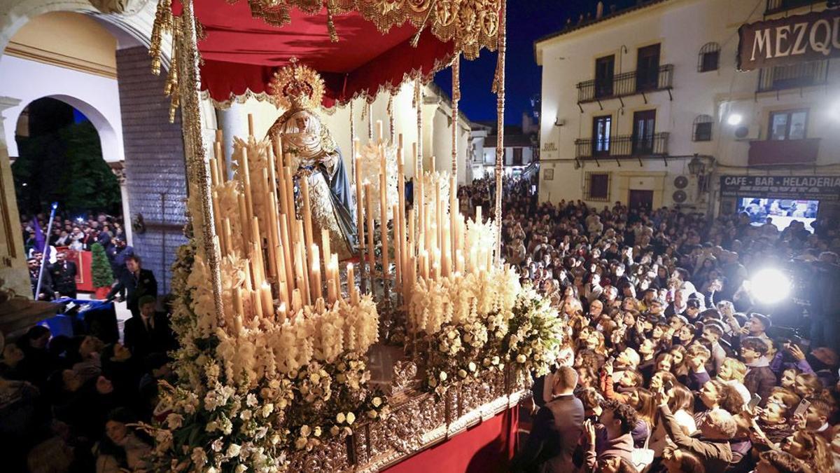 Una multitud se agolpa para contemplar el palio de la Virgen de la Salud a la salida de la carrera oficial.