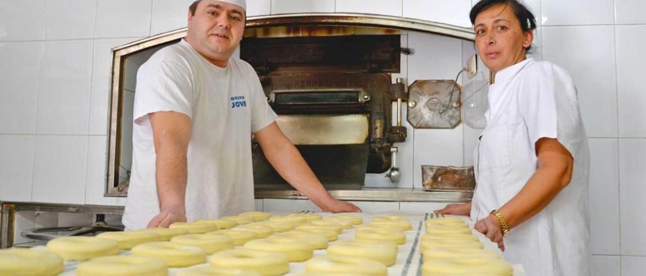 César García Alonso y María José García González, ante el horno de la panadería, elaborando donuts.