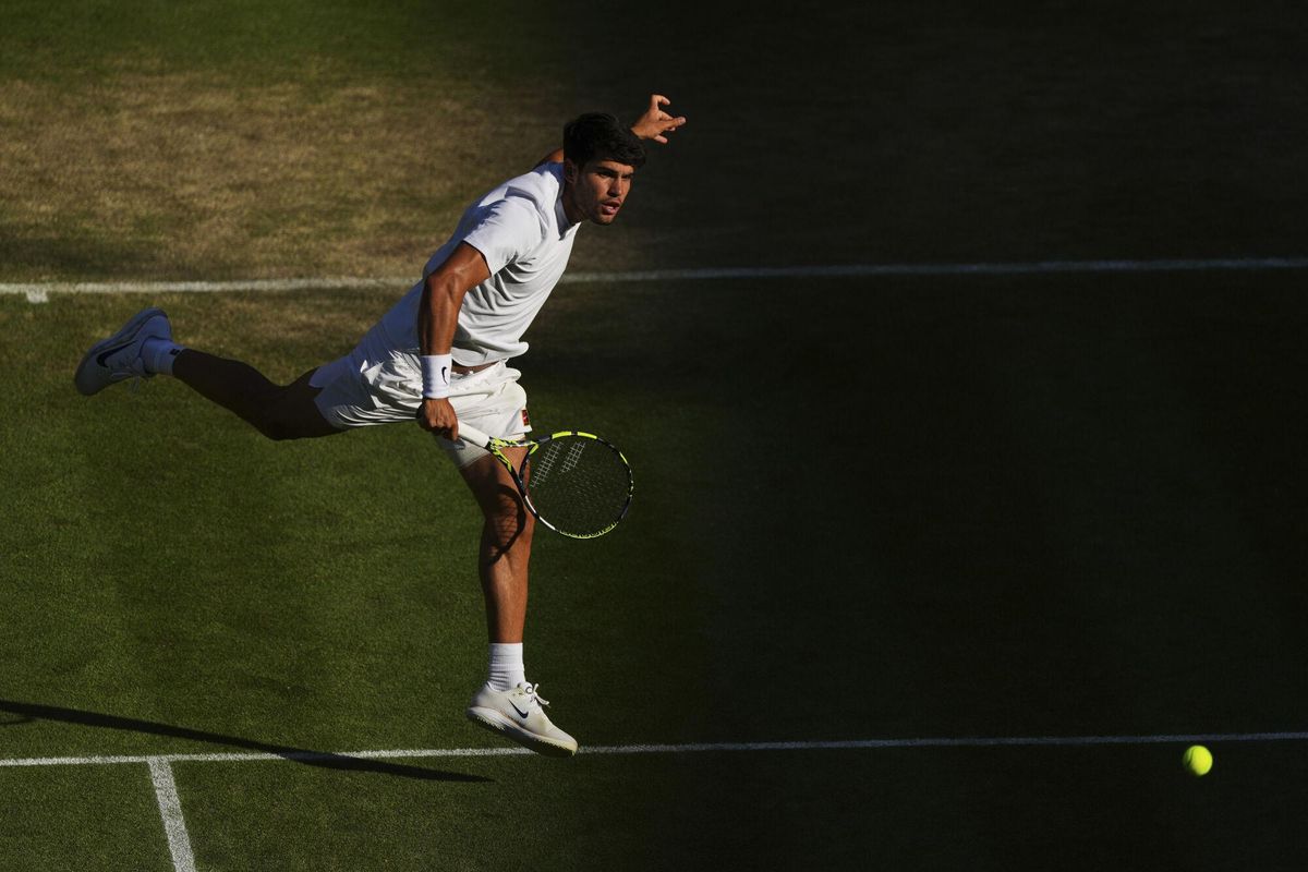 Spains Carlos Alcaraz returns to Britains Cameron Norrie during a quarterfinal mens singles match at the Wimbledon Tennis Championships in London, Tuesday, July 8, 2025. (AP Photo/Joanna Chan)