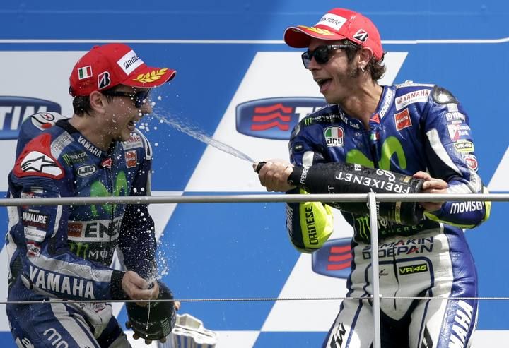 Yamaha MotoGP rider Lorenzo of Spain celebrates on the podium with his team mate Rossi of Italy after the Italian Grand Prix at the Mugello circuit