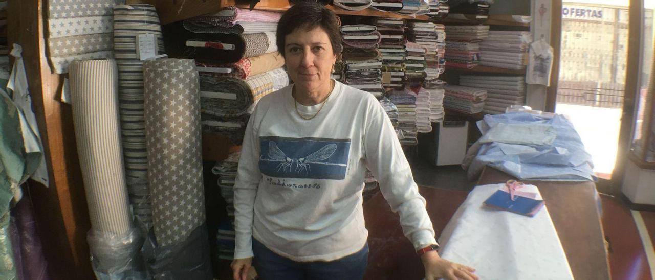 Maria Antònia Fuster posa entre telas, tijeras y cintas métricas en la tienda de Can Fernando. | SEBASTIÀ SANSÓ