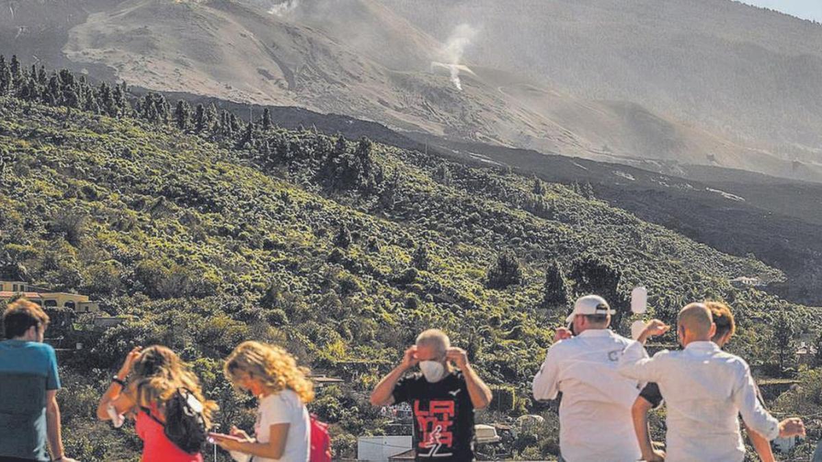 Un grupo de turistas observa el volcán Tajogaite.