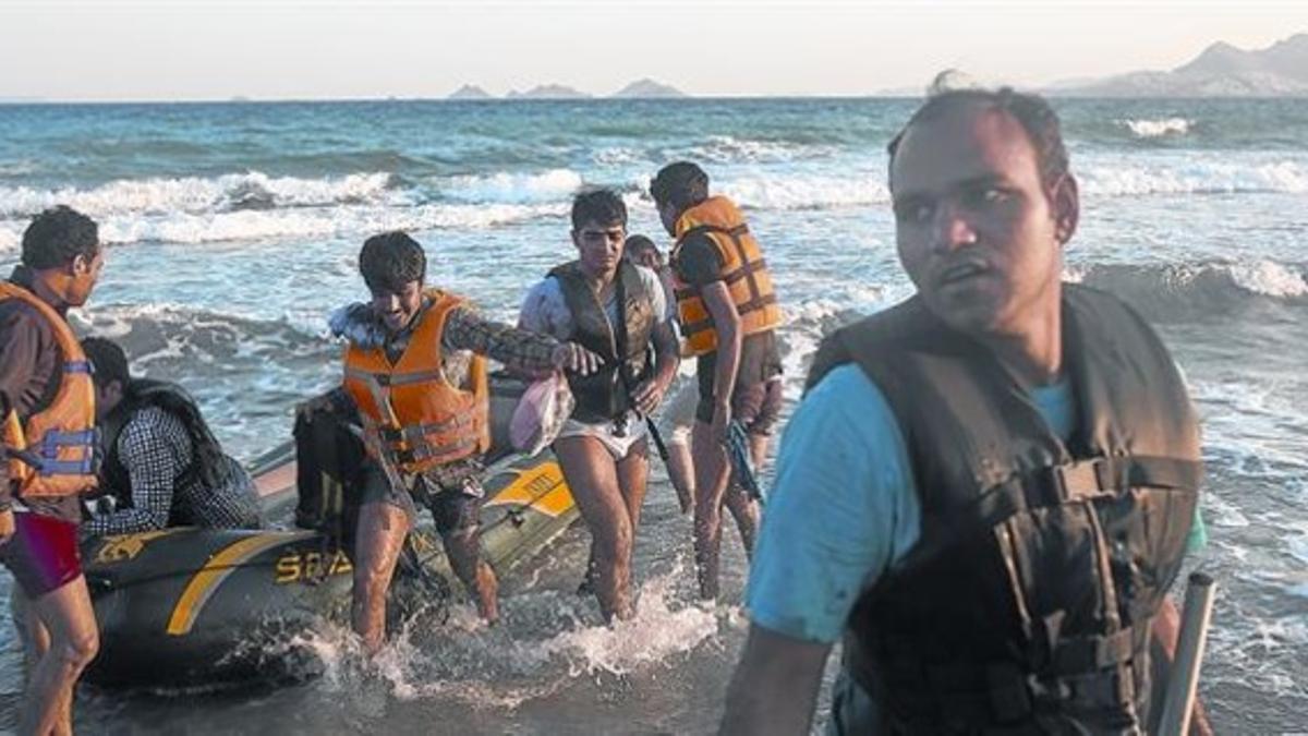 Un grupo de inmigrantes originarios de Bangladés desembarcan en una playa de Kos tras horas de travesía desde Turquía.