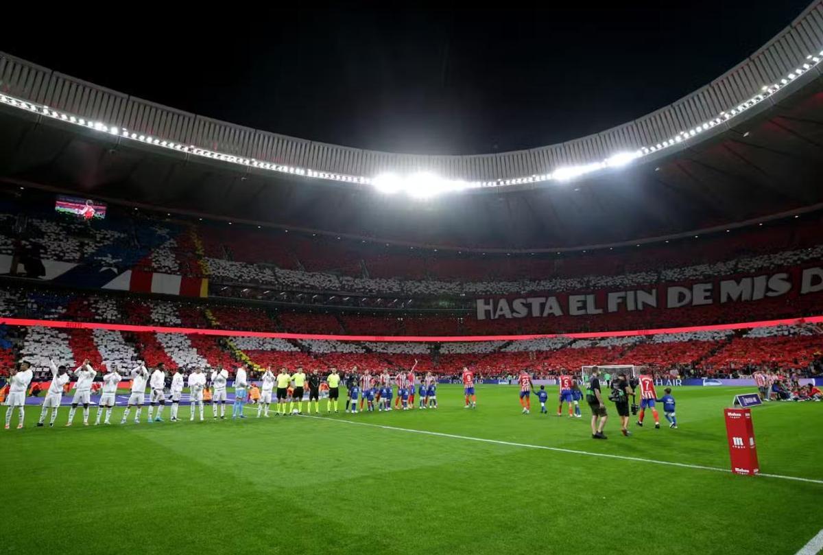 Los jugadores de Atlético y Real Madrid, antes de iniciarse el pasado derbi de Liga en el Metropolitano.
