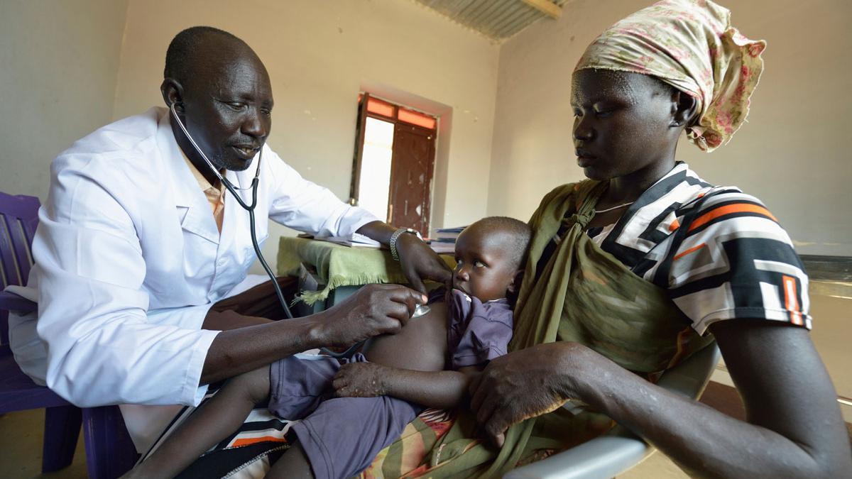 Un niño mira desconfiando al doctor que le ausculta en el CHTI de Wau (Sudán del Sur).
