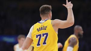 Los Angeles Lakers guard Luka Doncic celebrates after making his first basket as a Laker, a three-point shot, during the first half of an NBA basketball game against the Utah Jazz, Monday, Feb. 10, 2025, in Los Angeles. (AP Photo/Mark J. Terrill)