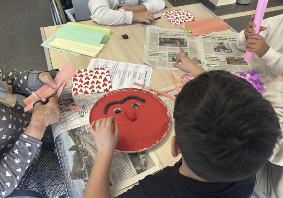 Dos momentos del taller de mascaradas en la residencia y el cartel realizado con inteligencia artificial (centro) sobre este proyecto educativo del CEIP Las Eras, en Benavente. | Cedidas