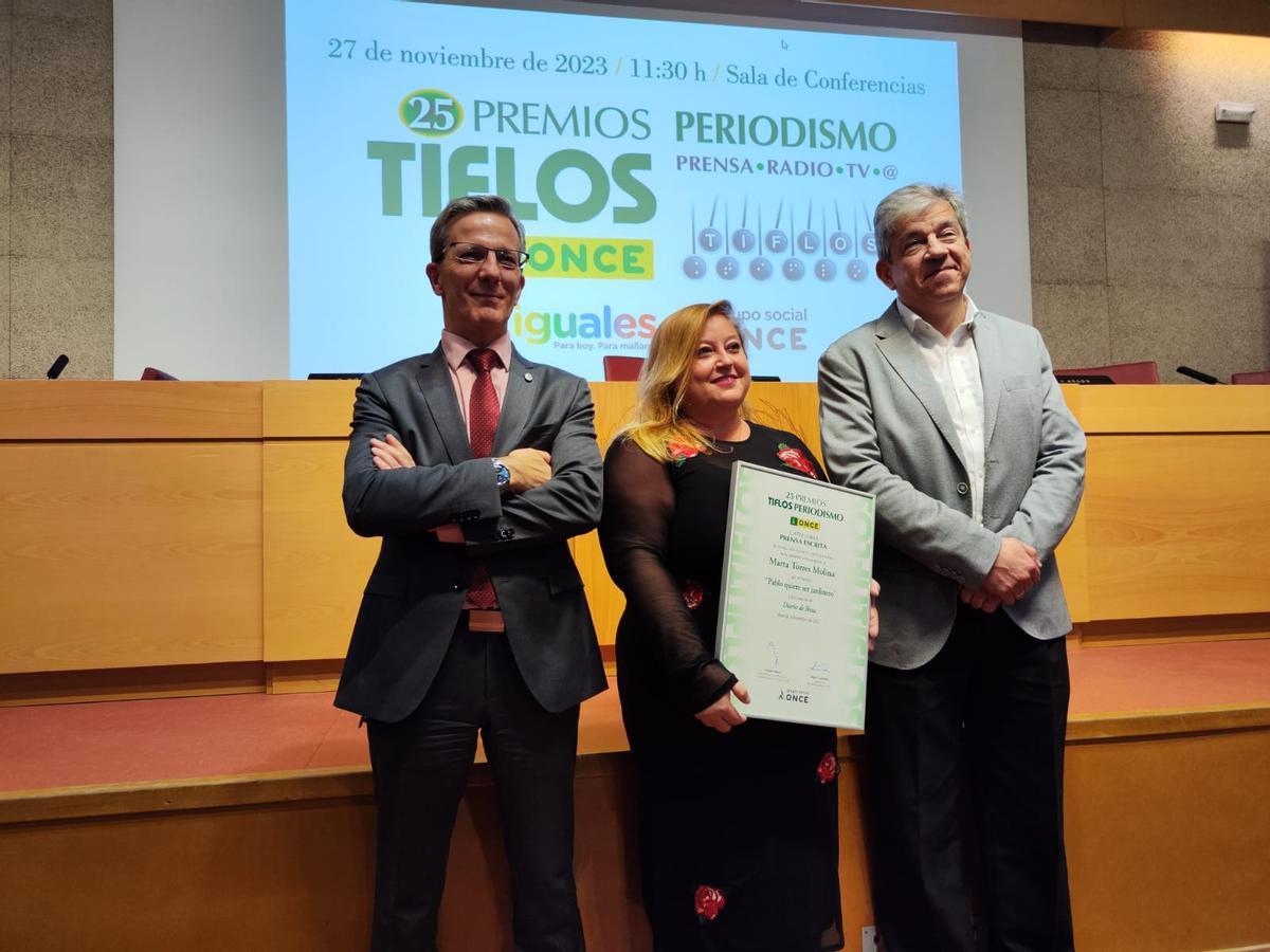 Marta Torres tras recoger el premio, entre el decano de la facultad de Ciencias de la Información, Jorge Clemente (izquierda), y Antonio Mayor, director de Comunicación del Grupo Social ONCE (derecha).